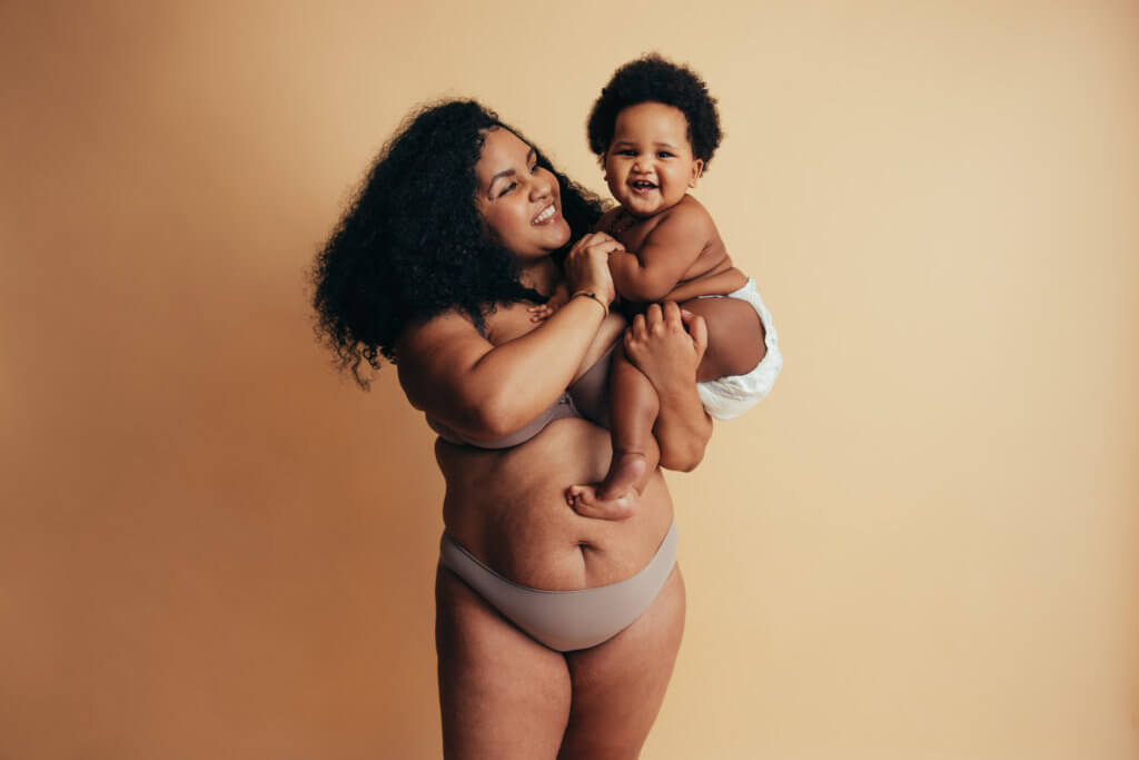 woman postpartum with child